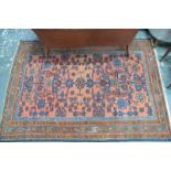 An old Persian Hamadan rug, the blue floral design on coral ground,