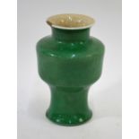 A green monochrome, Chinese vase with cylindrical body and trumpet neck; 18cm high,