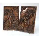 A pair of Continental chestnut relief-carved panels, depicting robed figures with cornucopiae,