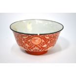 A Chinese porcelain, coral-ground bowl, decorated on the exterior with scrolling, floral designs,