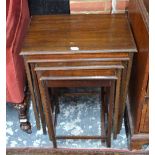A nest of four graduated mahogany occasional tables bearing trade plaque for Waring & Gillow Ltd