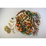 A collection of vintage jewellery comprising pair of enamelled brooches, simulated pearl necklaces,