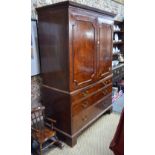 A Victorian mahogany dwarf linen press having a pair of panelled doors enclosing three oak slides,