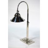 An adjustable nickel plated desk lamp in the Art Deco manner with conical shade and stepped square