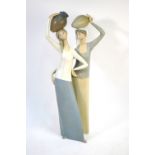 A Lladro matt glazed figural group of two women carrying amphora,