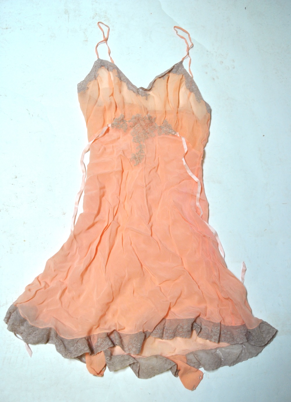 A pale blue silk georgette negligee edged with peach lace,