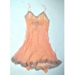 A pale blue silk georgette negligee edged with peach lace,