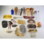 A collection of various haircombs and slides, hat pins,