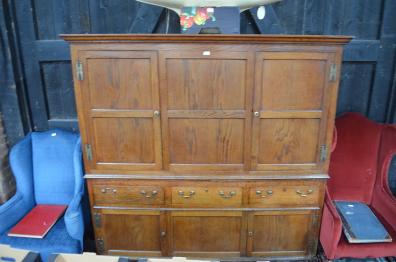 An 18th century oak country housekeepers cupboard in two parts,