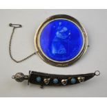 A circular blue enamelled St Christopher brooch in silver frame to/w Kukri style brooch set blue