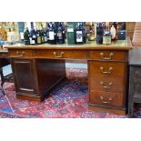 A late 19th/early 20th century mahogany pedestal partners desk,
