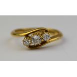 A three stone old cut diamond crossover ring, 18ct yellow gold claw setting, approx 0.