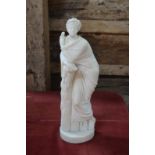An alabaster cloaked classical figure with laurel wreath and scroll,