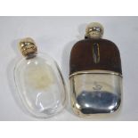 An Edwardian hip flask with silver hinged bun cover and detachable beaker, leather sleeve,