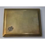 A 9ct yellow gold slide action engine turned cigarette case having applied monogram,