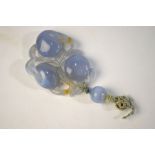 AMENDED DESCRIPTION A carved blue jade or jade style pendant of fruit and vine,