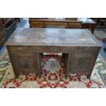 An antique carved hardwood Anglo-Indian pedestal desk,