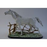 A cold-painted cast iron figure of a white stallion,