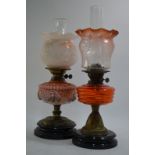 An oil lamp on circular base, decorated with a tulip design around the bowl,