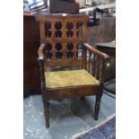 An 18th century country oak elbow chair,