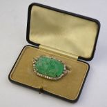 An Art Deco carved pale emerald brooch having old cut diamonds around, approx 4 x 2.