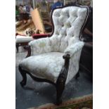 A Victorian mahogany show-framed button upholstered armchair with serpentine formed seat,
