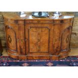 A Victorian inlaid and ormolu mounted burr walnut credenza with bow end arched panelled cupboards