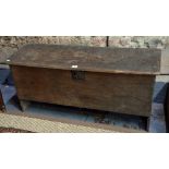 A 17th century oak six plank coffer raised on stile ends,