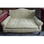 An upholstered two seat hump back sofa circa 1900,