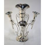 A large silver epergne with central trumpet-shaped vase flanked by three smaller vases on scrolling