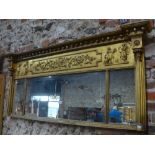 A Regency giltwood and gesso overmantel having triple mirror plates beneath an inverted breakfront