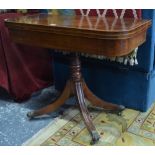 A Regency satinwood strung and cross-banded tea table, the fold over top enclosing a storage well,