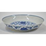A blue white circular dish decorated with floral designs; 20cm diameter,