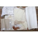 A vintage Revelation suitcase of assorted table linen including damask tablecloth, anti-macassars,