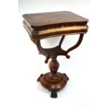 A 19th century Continental figured walnut work table with hinged top enclosing an interior of