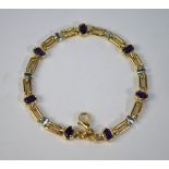 A 9ct yellow gold linked bracelet set with seven oval amethysts, approx 19 cm long including snap,