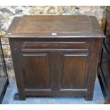A panelled oak chest with hinged top, of 18th century origins,