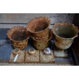 A set of four Victorian cast iron garden urns on stemmed square bases (a/f - one lacks base),