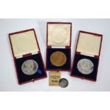 Two cased 1902 silver Coronation medals, a bronze example, 5.
