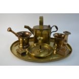 A brass pestle and mortar, hot water canister, chamberstick, another mortar,