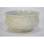 A white monochrome cup decorated with a dragon beside clouds; 7cm diameter; with unglazed exterior;