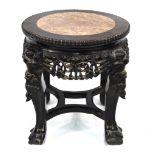 An antique Chinese veined marble inset carved hardwood stand of cylindrical form,