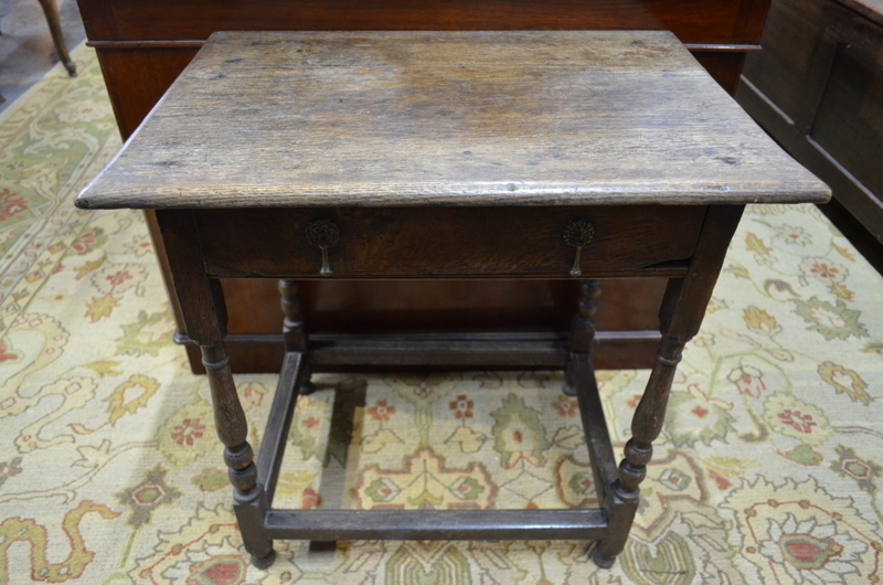 A 17th century oak side table with frieze drawer,