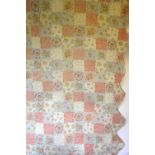 A reversible pastel floral machined patchwork quilt with scalloped edge,