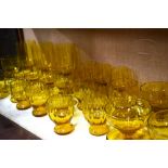 A collection of amber glass including ten small tumblers, 8 cm h., five wine glasses, 11 cm h.