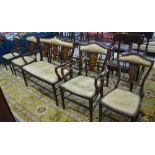 A late Victorian ivorine inlaid red walnut salon suite comprising five pieces, a two seat settee,