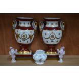 A pair of small Vienna or Vienna-style porcelain vases in rococo form, 11 cm high,