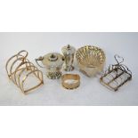 Two small silver toast racks, a shell butter dish, a napkin ring,