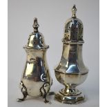 A set of three George II silver baluster casters with urn finials and domed pedestal bases,