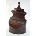 An antique hanging spoon rack with slope top brass bound salt box,